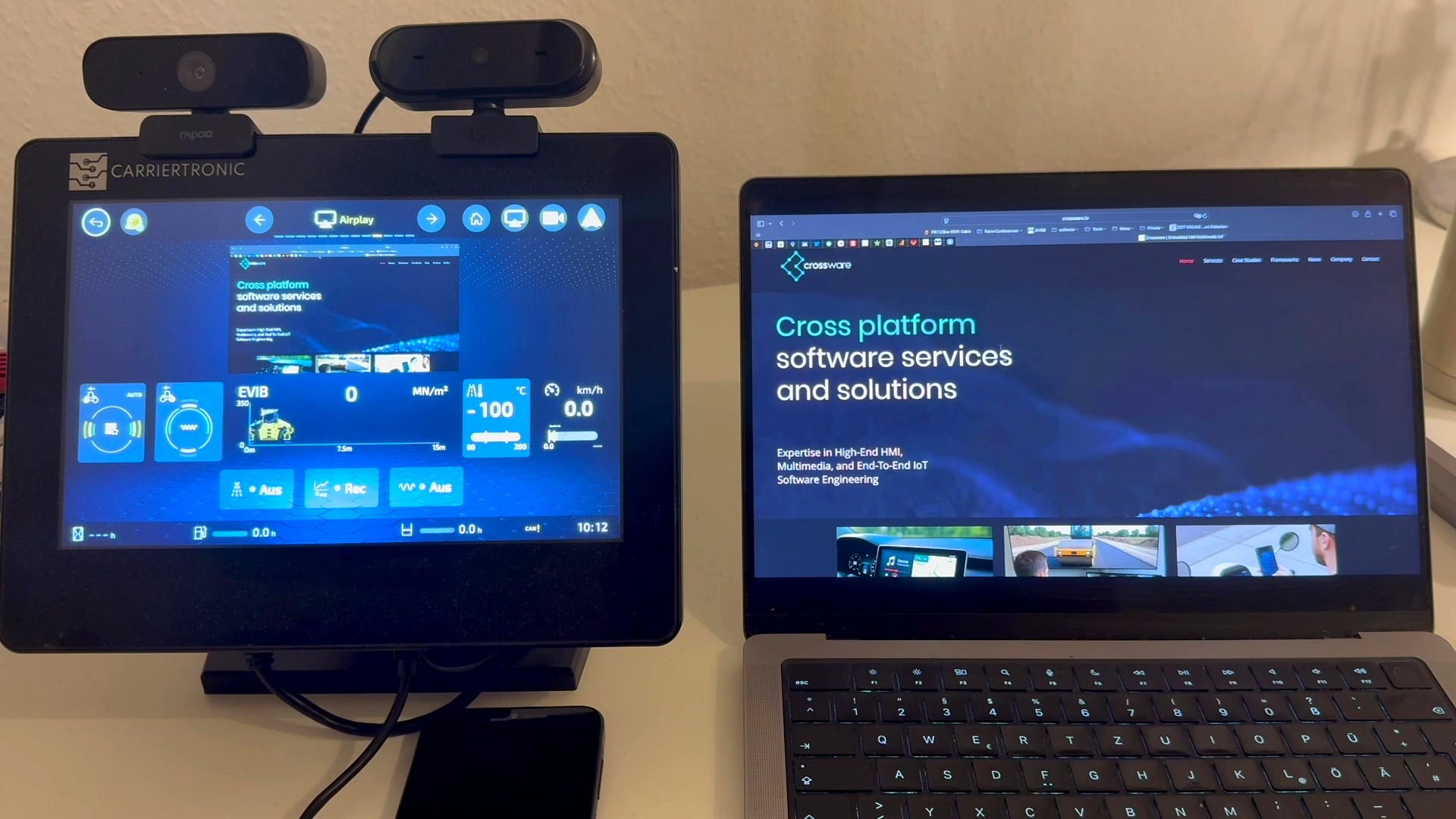 CrossPlay AirPlay integration — MacBook content projected to embedded display and mirrored simultaneously